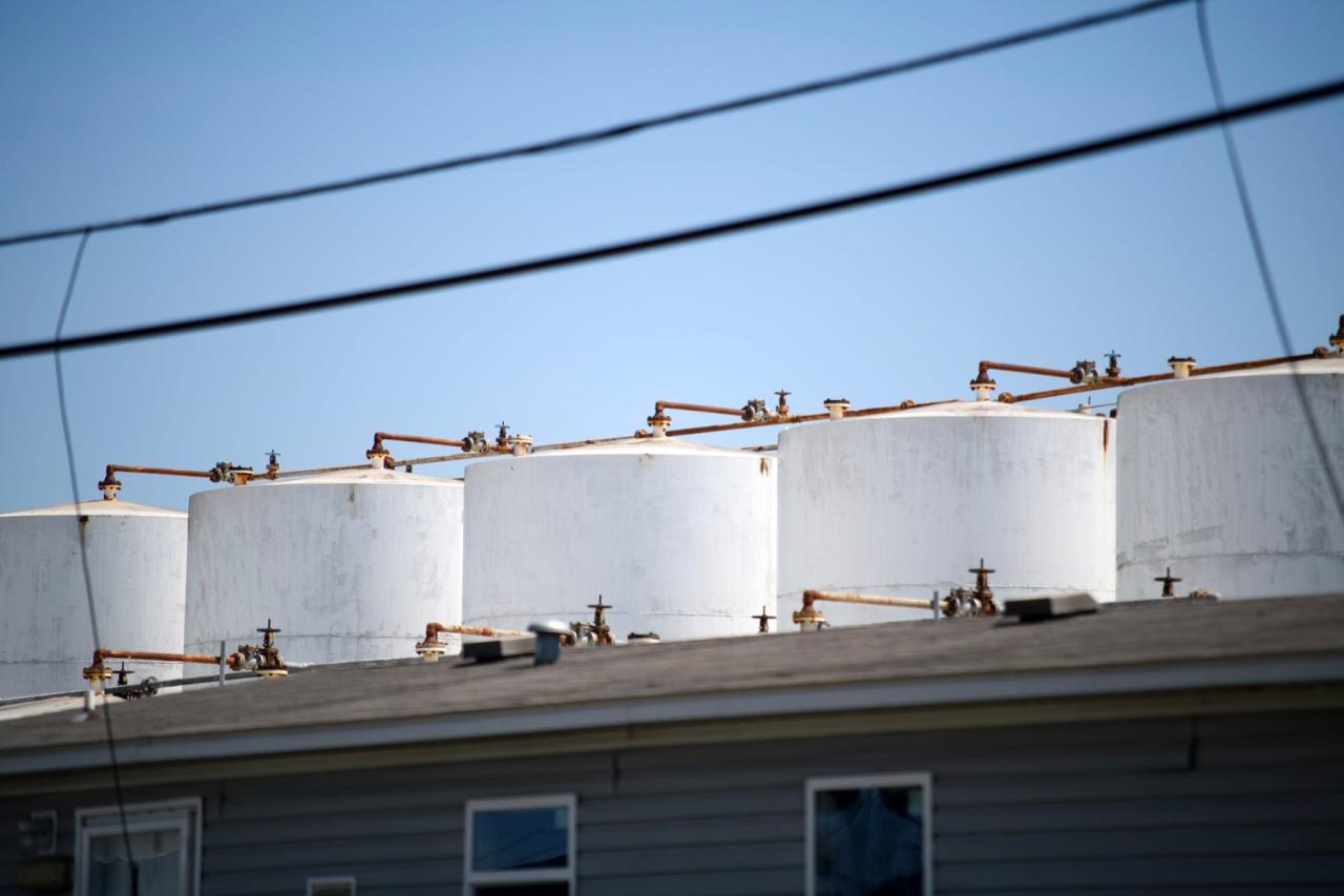 A row of tanks looms above an office building at K-Solv's chemical distribution facility.